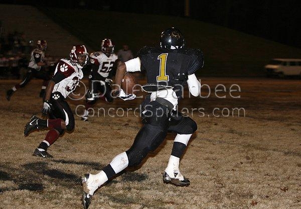 Lance Lewis streaks past two Cougar defenders.